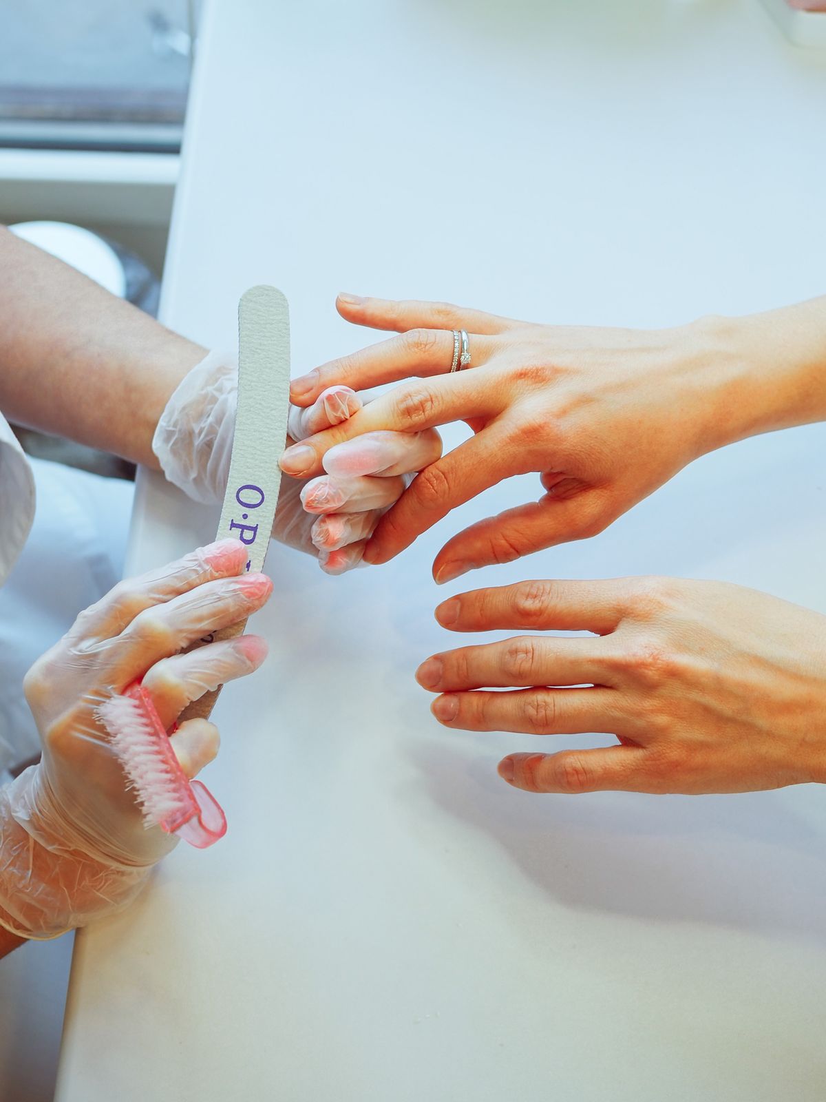Professional manicure tools being used during a nail care session