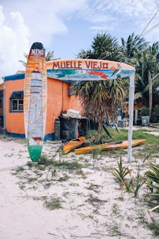 Vibrant entrance of 'Muelle Viejo' seafood restaurant at a tropical beach in Mexico.