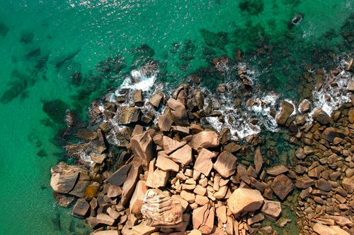 Free Discover the stunning rocky shoreline and turquoise waters of Kijal, Malaysia from above. Stock Photo