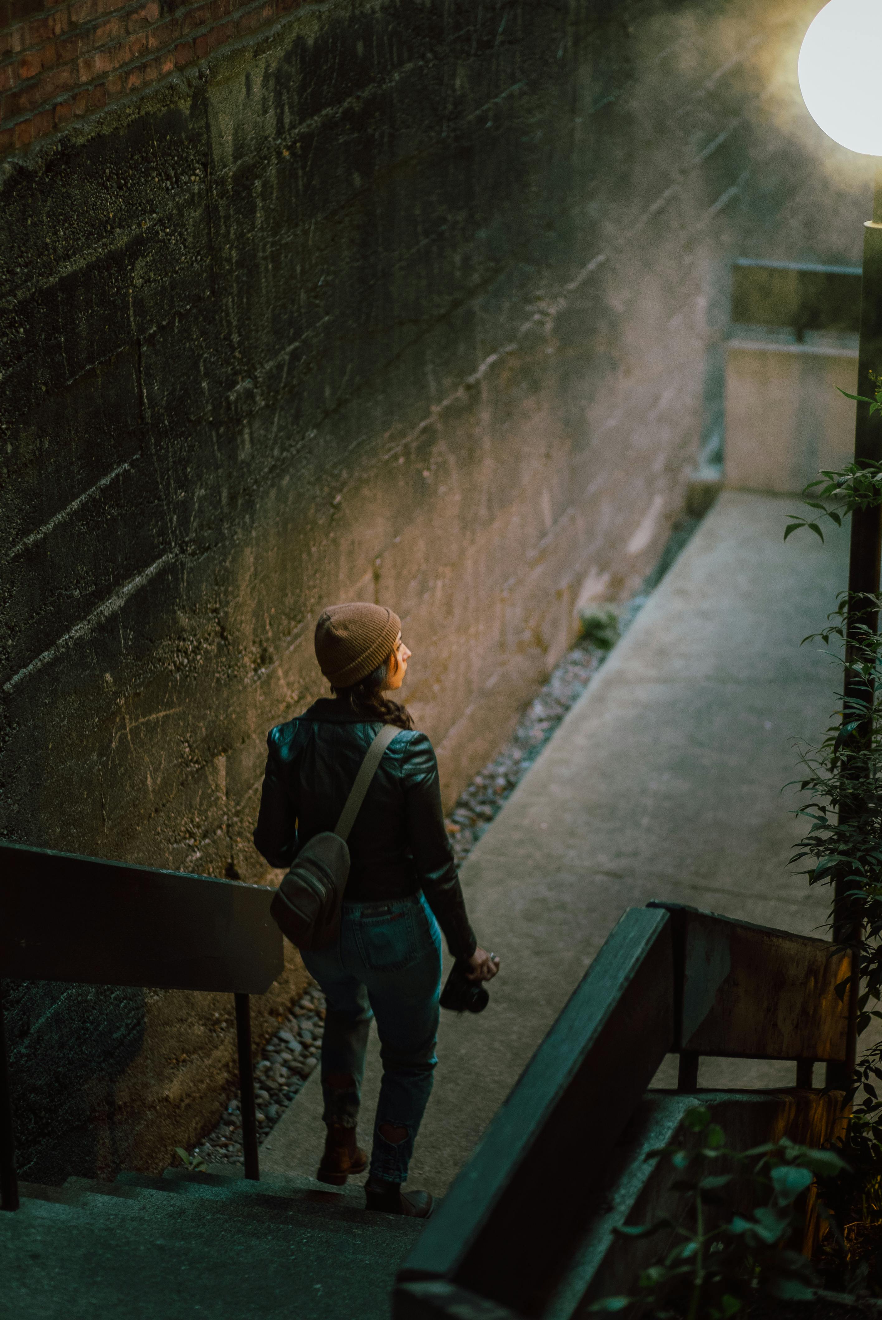 a woman wearing beanie going down the stairs