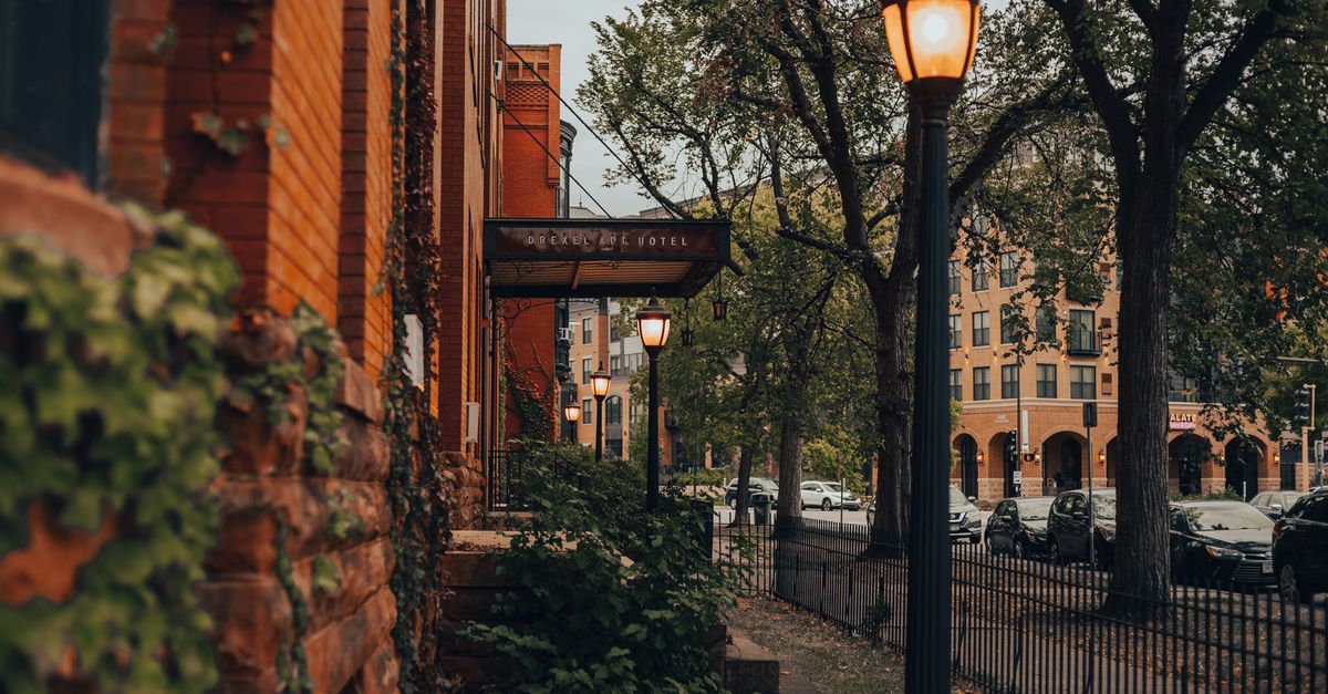 Street lamps illuminate a historic brick building street scene in Minneapolis, creating a nostalgic mood.