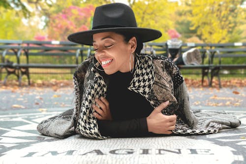 A Woman Wearing Black Hat Smiling