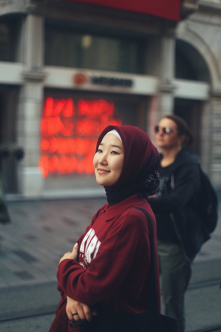 A Woman Smiling In A City