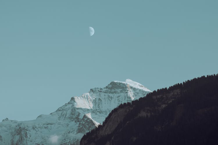 Moon In Sky Over Mountain Peak