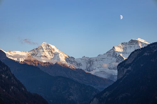 Half Moon over the Snow Covered Mountain