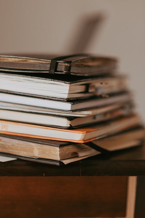 Stack of Notebooks on Table