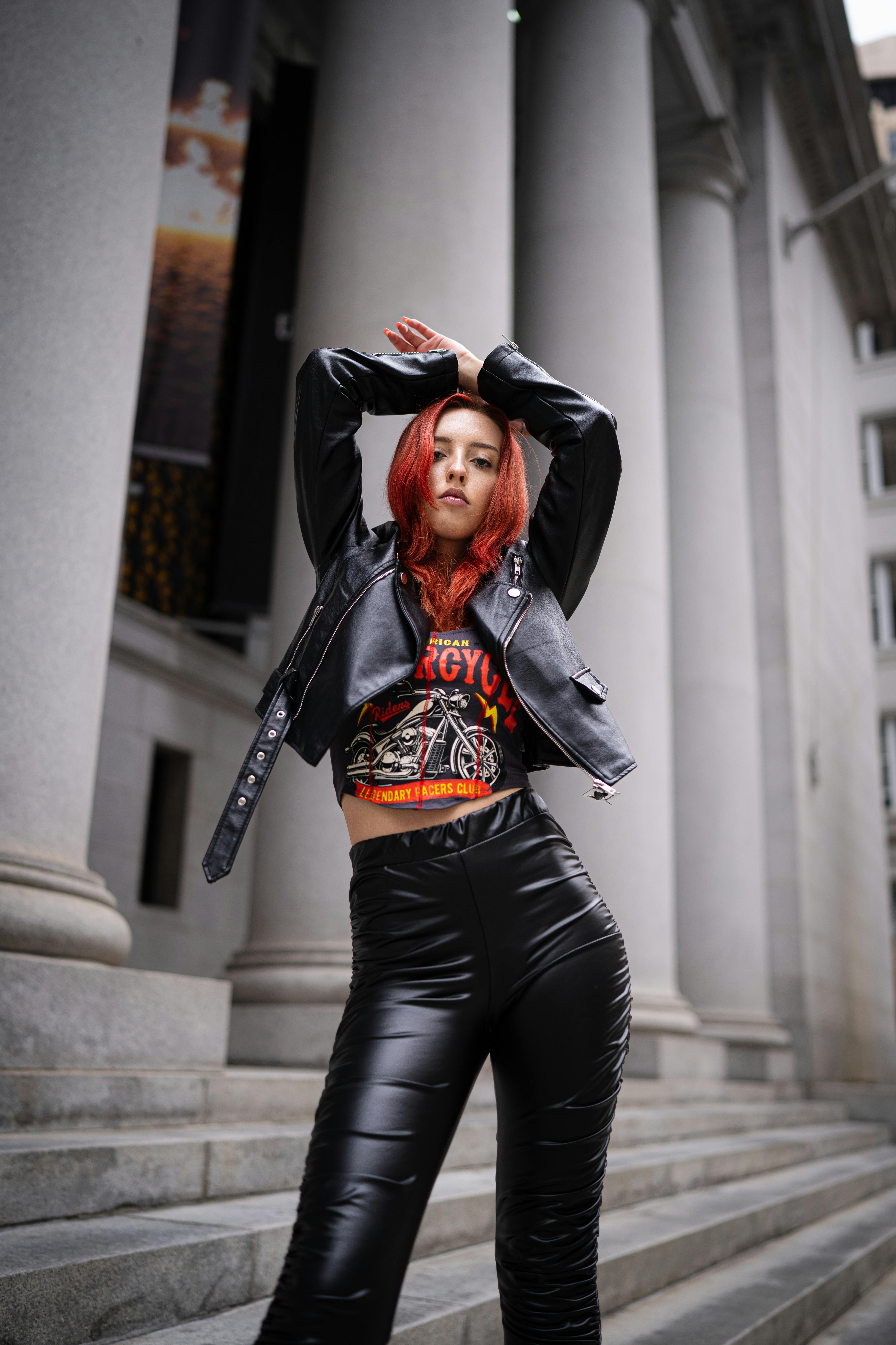 beautiful redhead woman wearing leather on city street