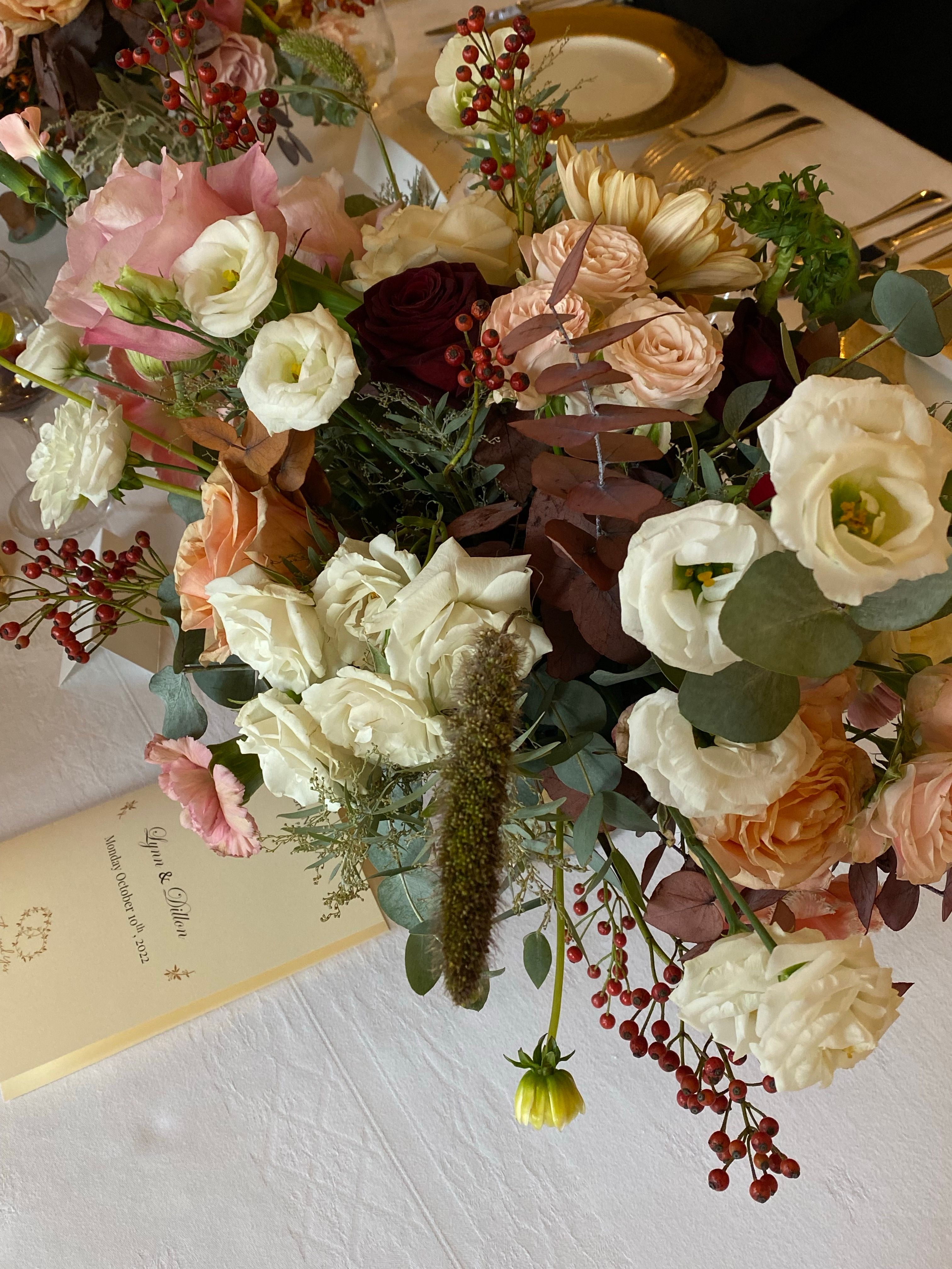 Delicate bouquet of roses and peonies beautifully arranged for a wedding.