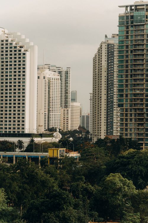 Free A stunning view of Jakarta's skyline highlighting tall skyscrapers and tropical greenery. Stock Photo