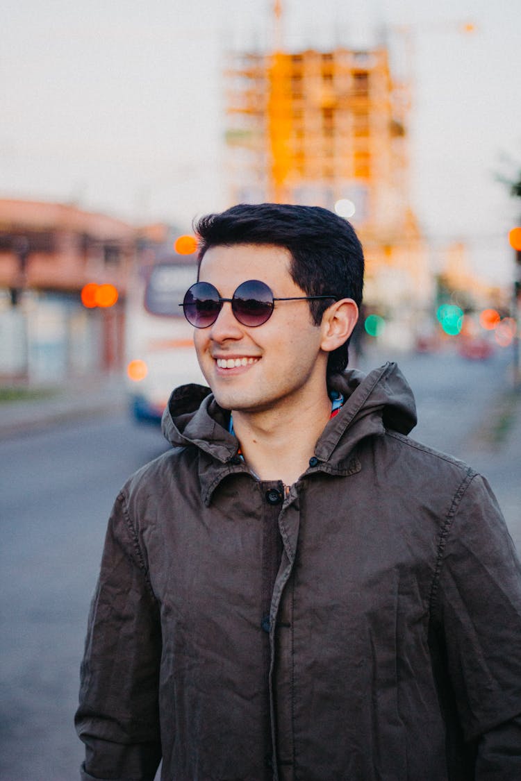 Portrait Of Smiling Man In Round Glasses