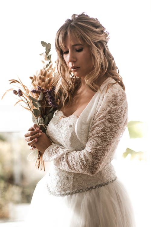 Free A Bride Holding Bouquet of Flowers Stock Photo