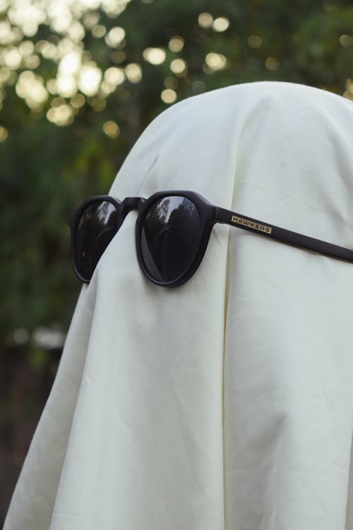 Close-up of a Person Dresses as a Ghost Wearing Sunglasses