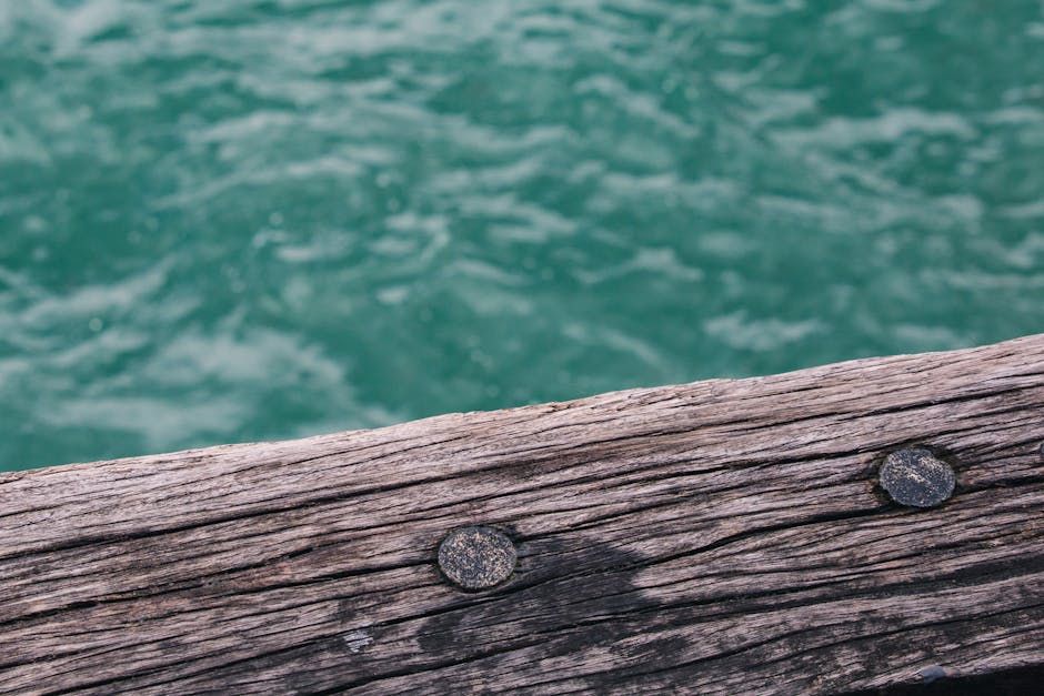Weathered dock with visible signs of wear like cracked boards - dock builders near me Weathered dock with visible signs of wear like cracked boards - dock builders near me