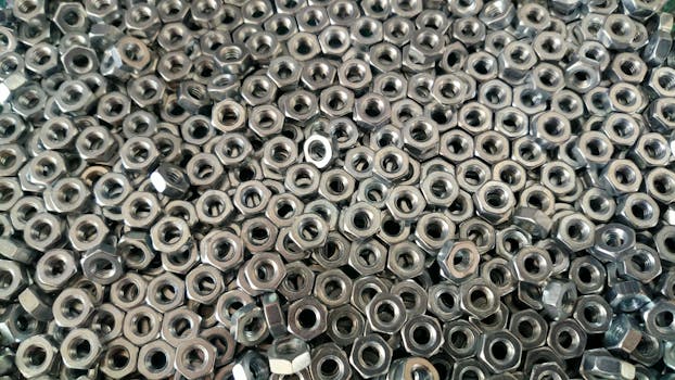 Detail of numerous stainless steel nuts creating an industrial texture.