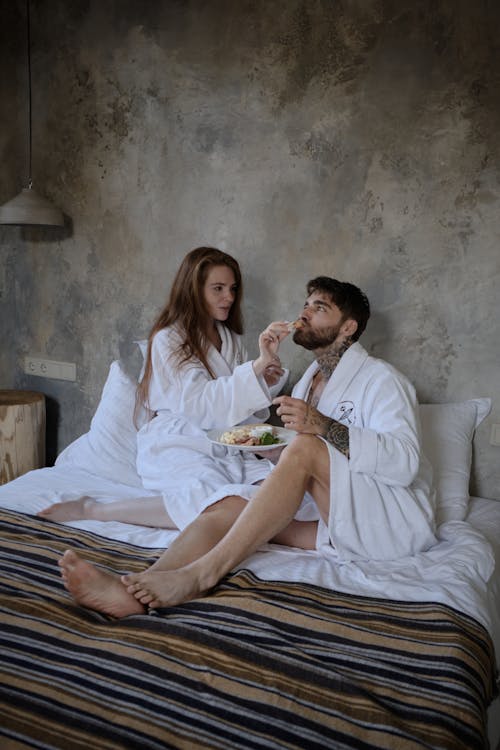 Free Woman and Man Relaxing on Bed Stock Photo