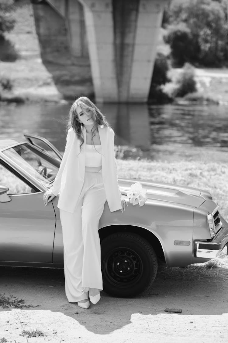 Woman Leaning On Car Near River