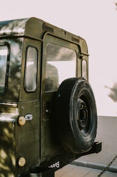 Close-up of an old military vehicle showcasing its rear end and spare tire.