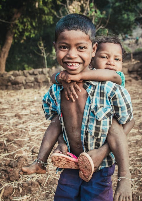 Free Boy Carrying a Child Stock Photo