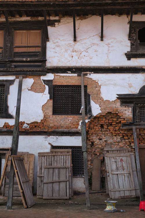 Free Weathered brick facade with wooden panels in Basantapur, highlighting historic architecture. Stock Photo