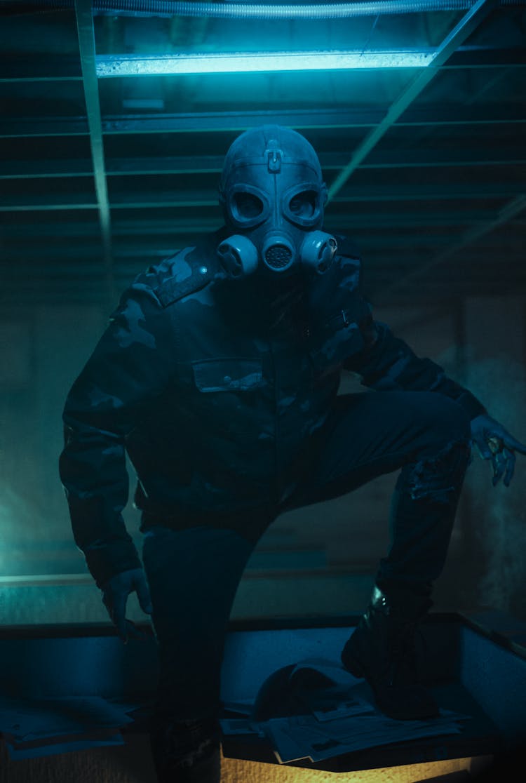 Man Wearing Uniform And Gas Mask In Room