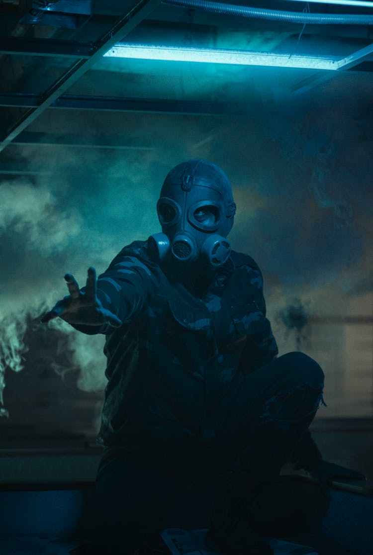 Unrecognizable Person In Gas Mask Gesturing