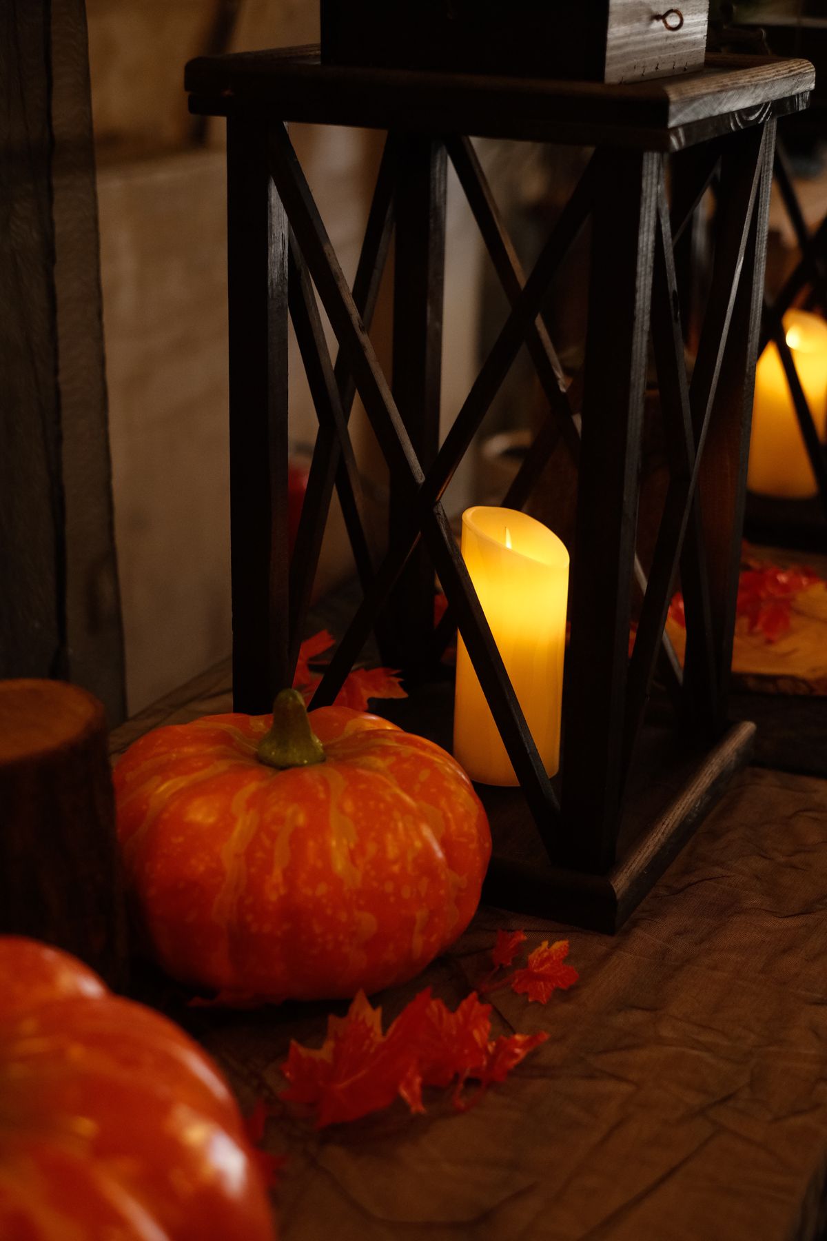 Pumpkins and candles in a rustic lantern setting