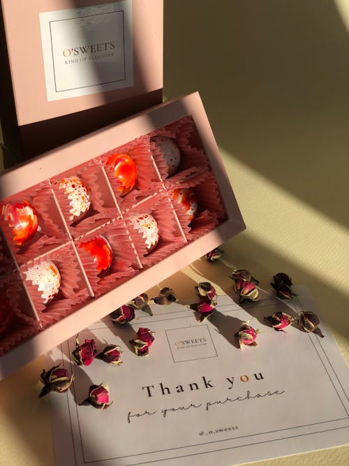 Close-up of a Box of Chocolate Pralines and a Thank You Card 