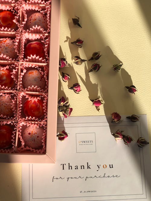 Close-up of a Box of Chocolate Pralines and a Thank You Card