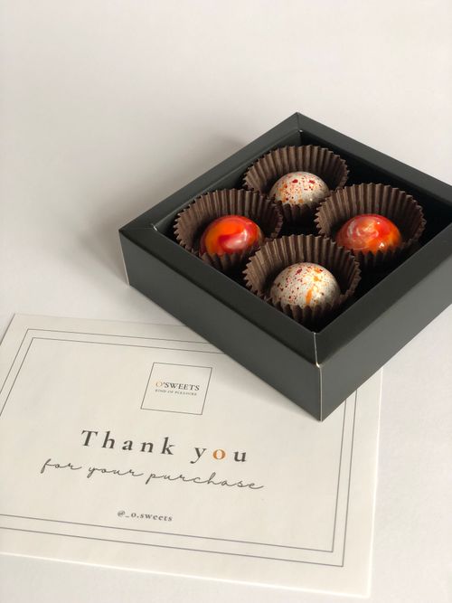 Free Elegant gift box of gourmet chocolates with thank you card. Stock Photo
