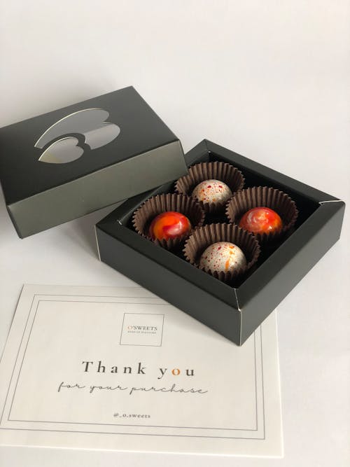 Close-up of a Box of Chocolate Pralines and a Thank You Card