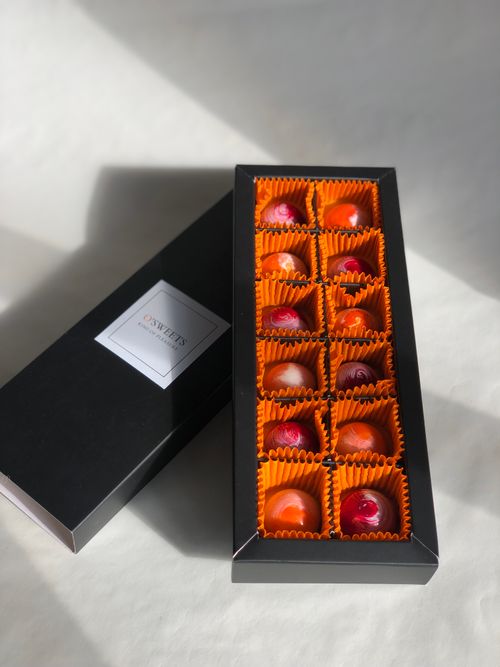 Free Luxurious selection of chocolates in an elegant box, perfect for gifting and indulgence. Stock Photo