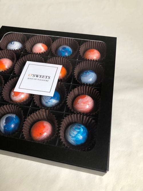 Free Elegant gourmet chocolates with a marble design in a gift box. Perfect for special occasions. Stock Photo