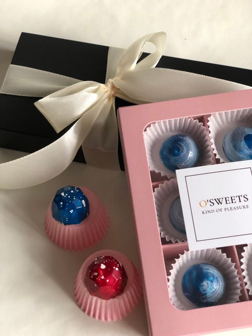 Free Elegant gift boxes with colorful truffles showcasing exquisite confectionery packaging. Stock Photo