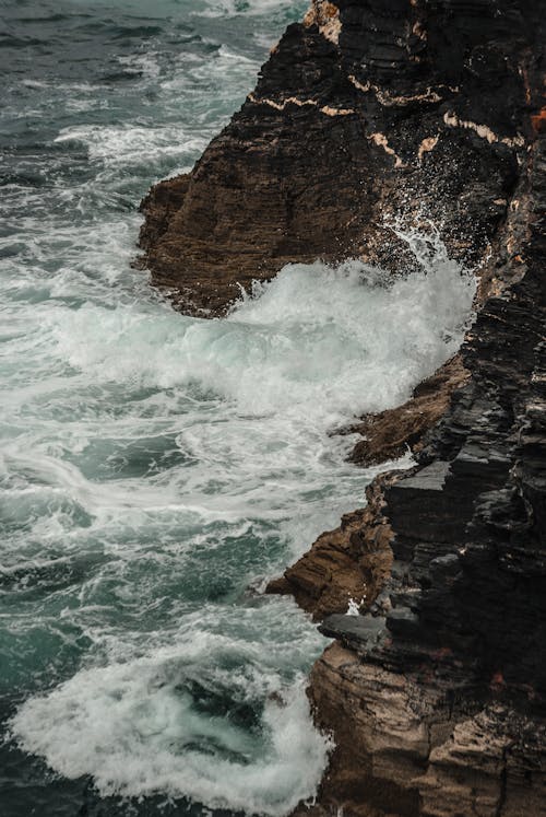 Brown Mountain Splashed With Water from Sea