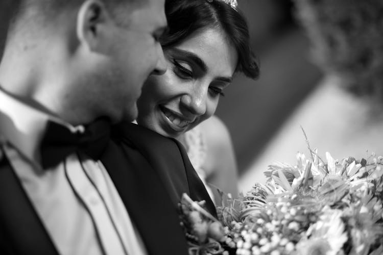 Smiling Bride Looking Over Shoulder Of Groom