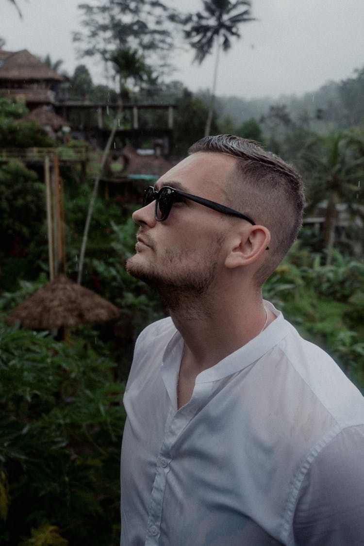 Man In Sunglasses With Asian Village In Background