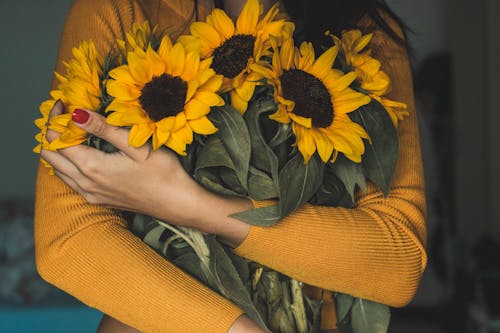 Femme Tenant Un Bouquet De Tournesols