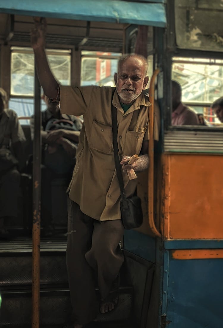 An Elderly Man Working In The Bus