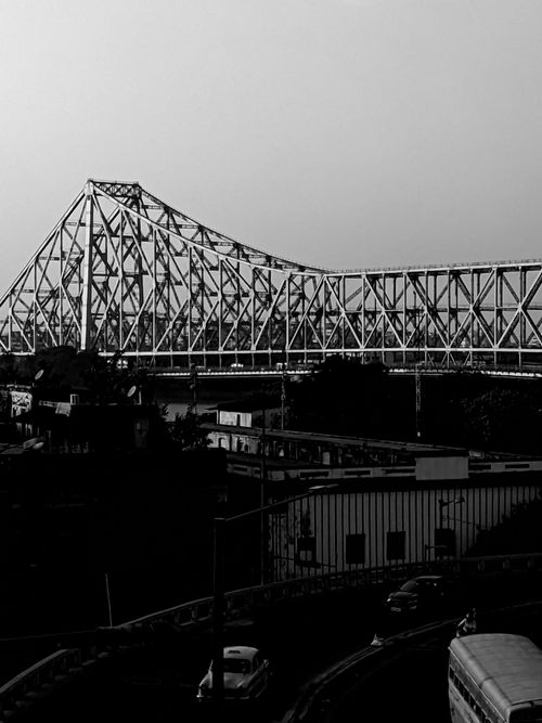 Free Dramatic black and white image of Howrah Bridge in Kolkata, showcasing its architectural grandeur. Stock Photo