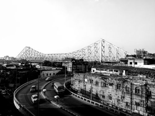 Free Black and white view of Howrah Bridge over Kolkata, capturing the urban landscape and traffic flow. Stock Photo