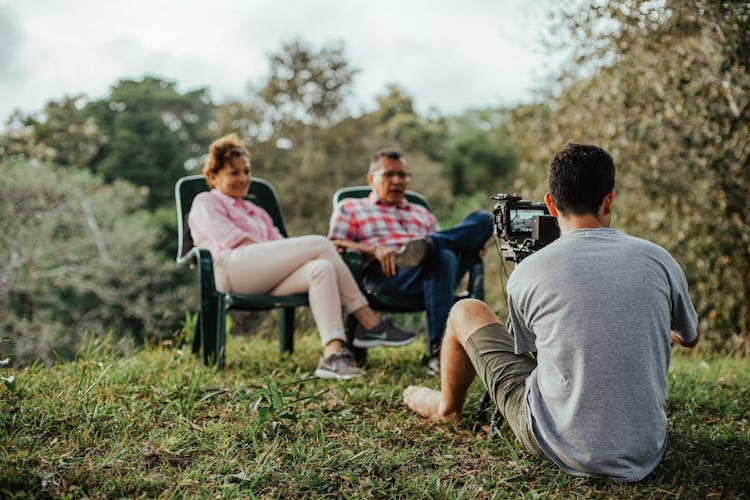 Photographer Taking Photo Of Couple In Garden