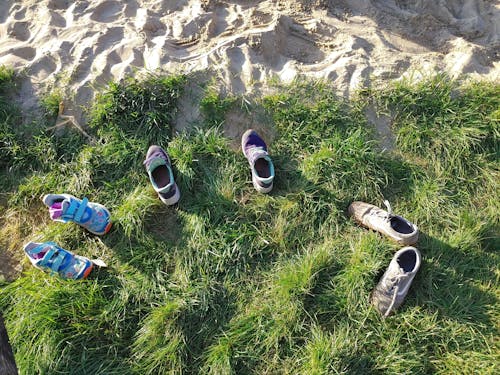 Free kids shoes next to sand pit Stock Photo