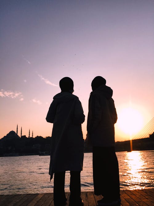 Silhouette of Couple in Harbor During Sunset 