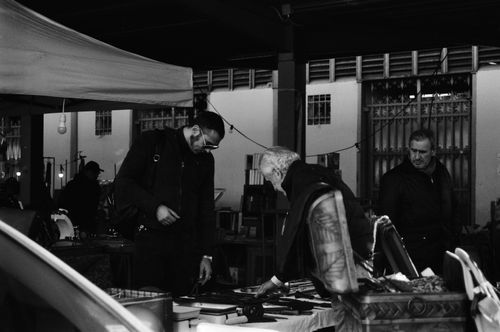 Free Black and white photo capturing a bustling market interaction in Florence, Italy. Stock Photo