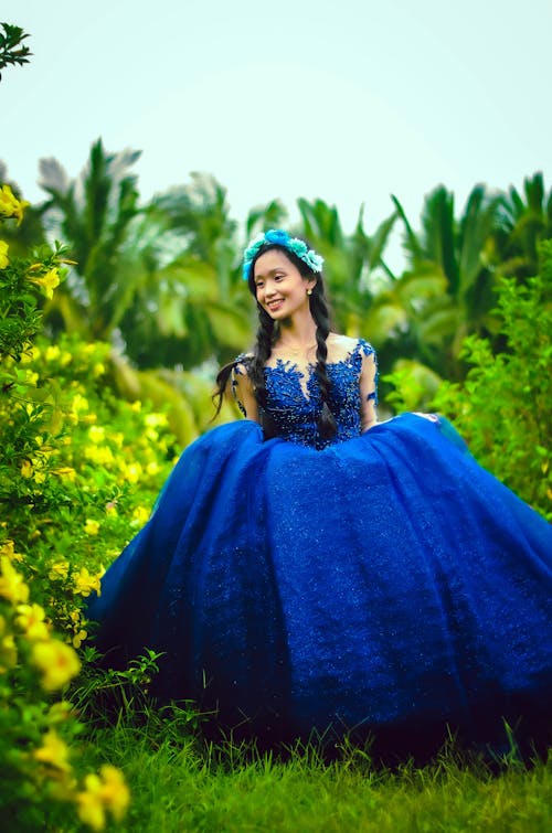 Woman in Blue Dress standing on Grass