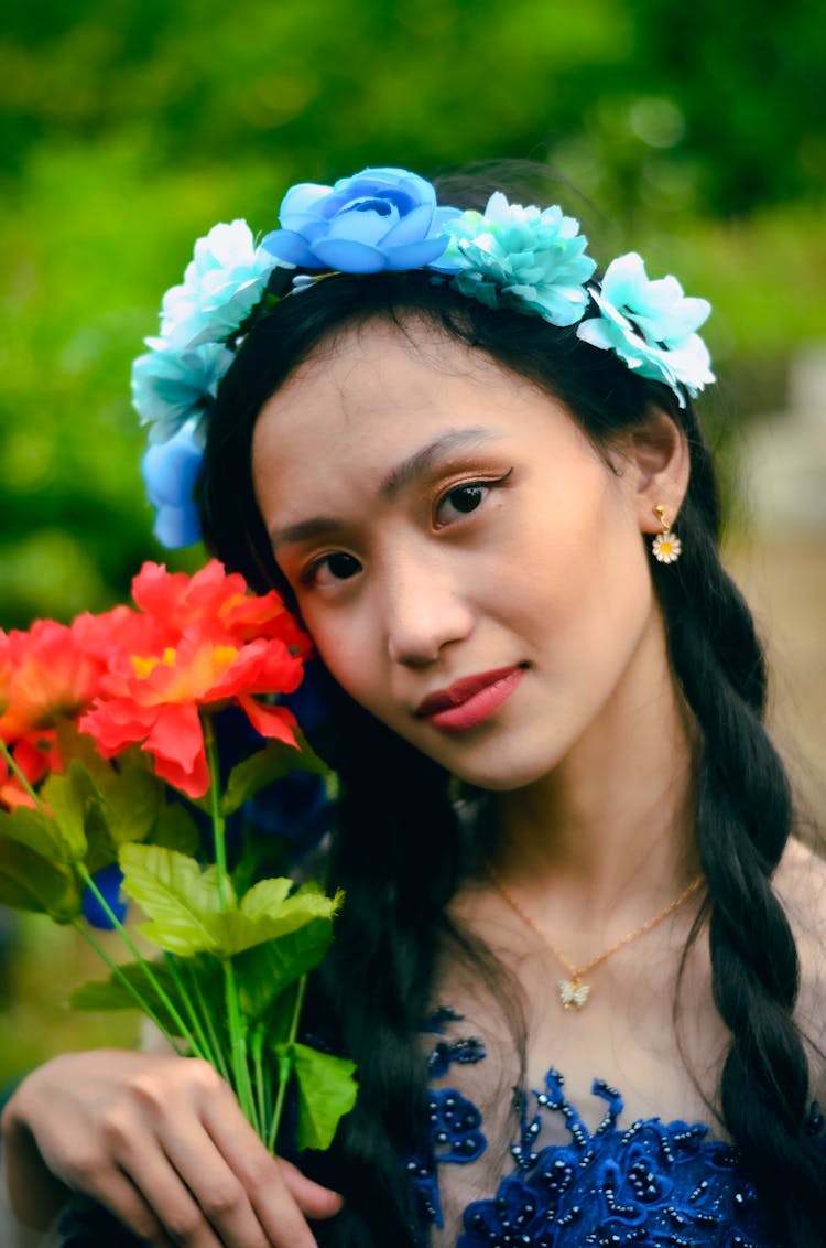 Close Up Photo Of Teenage Girl Holding Red Flowers