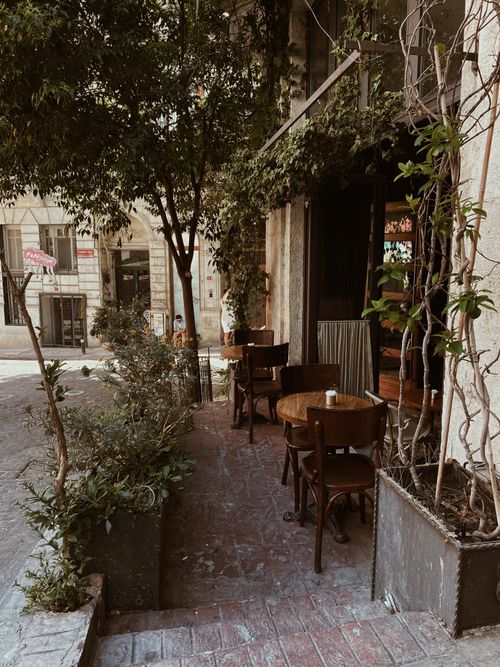 Free Cozy outdoor café setting on a leafy street in Istanbul, Turkey. Stock Photo