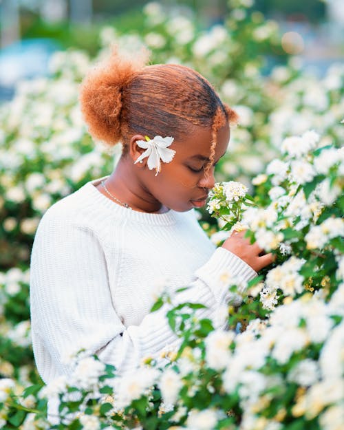 Woman Smelling White Flowers