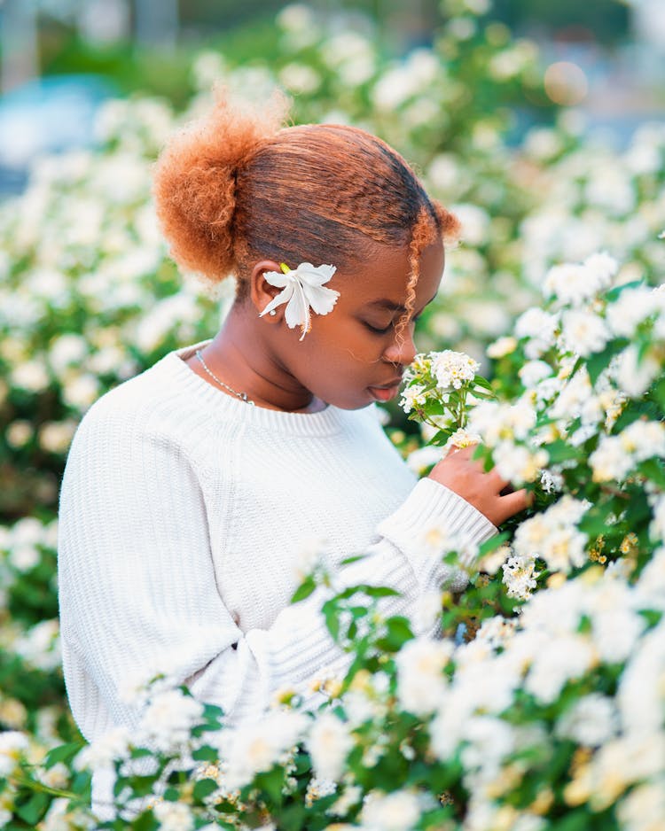 Woman Smelling White Flowers