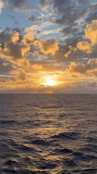 Capture of a breathtaking ocean sunset with vibrant clouds and shimmering water, ideal for serene and calming visuals.